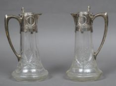 A pair of German silver mounted claret jugs, hallmarked for 800 Standard,
