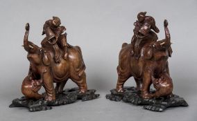 A pair of late 19th/early 20th century Chinese carved wooden models of elephants Each mounted with