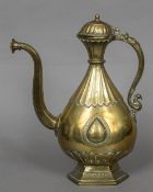 An 18th century Indian Deccan brass ewer The tear shaped body with lappet casting and engraved