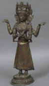 An Eastern cast bronze figure of a deity Modelled standing on an integral plinth base. 48 cm high.