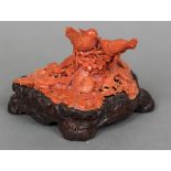 A Chinese carved coral group Worked as birds and rodents amongst floral sprays,