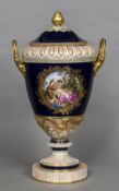 A large 19th century Berlin porcelain vase and cover The removable lid flanked by twin scrolling