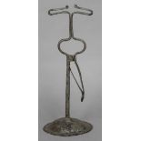 An 18th/19th century wrought iron rush nip Of sprung design, standing on a domed spreading foot.