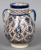 A 19th century Qajar pottery vase Of twin handled ovoid form. 23 cm high.