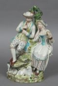 A Staffordshire pottery group Modelled as a shepherd and shepherdess. 26.5 cm high.