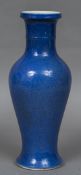 A Chinese porcelain baluster vase Of slender form, with allover mottled blue glaze,
