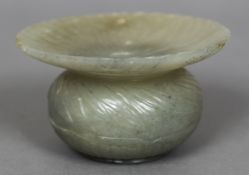 An 18th/19th century Mughal carved jade vase The fluted flared rim above a compressed spherical