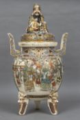 A large Japanese satsuma pottery twin handled koro and cover The pierced lid with figural finial,