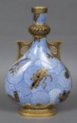 A Royal Worcester porcelain twin handled Aesthetic moon flask Blue and white transfer and gilt