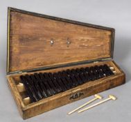 A 19th century satinwood cased Bristol blue glass xylophone Inscribed G.