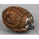 A 19th century carved coquilla nut snuff bottle Carved with the heads of three dignitaries.