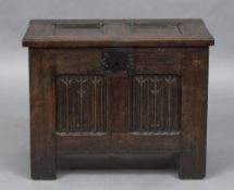 A small 17th century French oak coffer The panelled hinged rectangular top above linen fold panels,