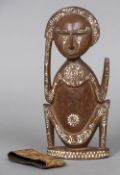 A New Guinea carved wood and lime inlaid tribal figure With paper labels to underside inscribed