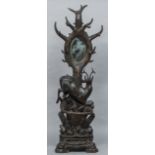 A late 19th century Black Forest carved wooden hall stand Formed as a deer before a tree on a rocky