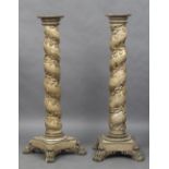 A pair of 18th century carved wooden torcheres Each of barley twist form with gilt trailing vine