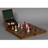 A late 19th century bone and stained bone Staunton pattern chess set Together with a folding