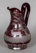 A 19th century Bohemian ruby overlaid cut glass ewer Decorated with deer in a woodland landscape.