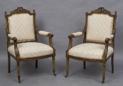 A pair of 19th century French carved walnut open armchairs Each with a ribbon tied top rail above a