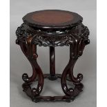 A 19th century Chinese carved hardwood and burrwood inlaid vase stand With pierced and carved apron,