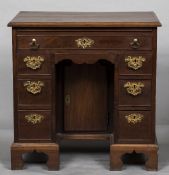 A George III mahogany kneehole desk The moulded rectangular top above a brushing slide and an