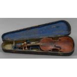 A 19th/20th century violin Of typical form, with lion mask carved scroll, cased. 60 cm long.