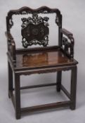 A 19th century Chinese carved hardwood open armchair With shaped top rail, carved and pierced splat,