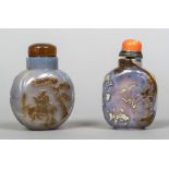 Two Chinese carved hardstone snuff bottles and stoppers On worked with a figure on horseback