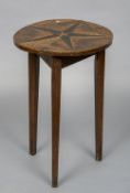 A 19th century parquetry topped cricket table The circular top inlaid with geometric motifs centred