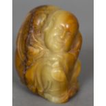 A Chinese carved soapstone figure of a sage Modelled crouching with a florally decorated gown. 8.