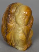A Chinese carved soapstone figure of a sage Modelled crouching with a florally decorated gown. 8.