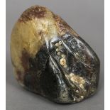 A small scholars rock Of natural form with attached barnacles. 9.5 cm high.