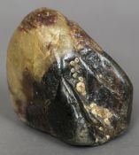 A small scholars rock Of natural form with attached barnacles. 9.5 cm high.