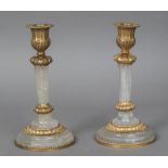 A pair of gilt metal mounted carved crystal candlesticks Each with fluted column,