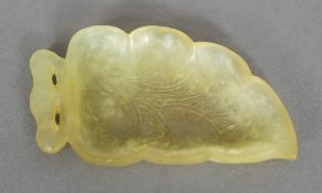A Chinese carved jade brush washer formed as a leaf 10.5 cm wide.