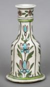 A 19th century Qajar/Iznik pottery hookah base Decorated on a white ground with floral sprays.