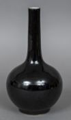 A Chinese porcelain bottle vase With allover famille noir glaze,