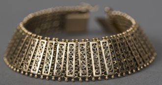 A 9 ct gold mesh form strap bracelet 19 cm long.