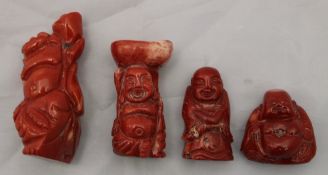 Four carved coral figures