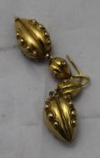 A pair of unmarked yellow metal earrings