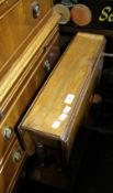 An Edwardian walnut two tier Sutherland table