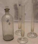 A glass apothecary jar and three glass specimen vases