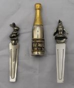 A champagne bottle retracting pencil and two pewter bookmarks