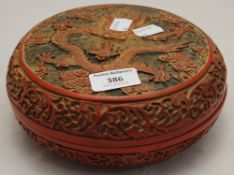 A round Chinese box and cover decorated with a dragon