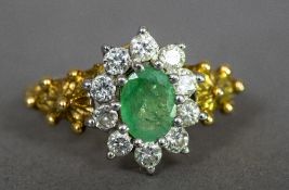 An 18 ct gold diamond and emerald cluster ring, of flowerhead form.