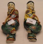 A pair of porcelain lying Chinamen