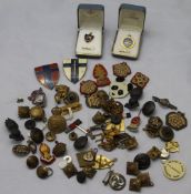 A quantity of military badges, buttons and others,