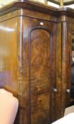 A Victorian walnut triple wardrobe