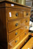 A reproduction tall boy chest