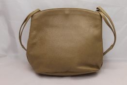 A large tan leather handbag