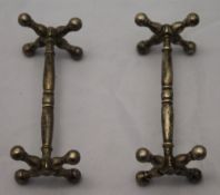 A pair of silver knife rests,